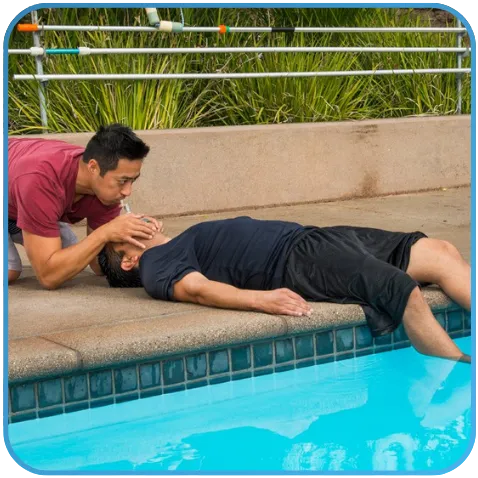 A person administering first aid near a pool.