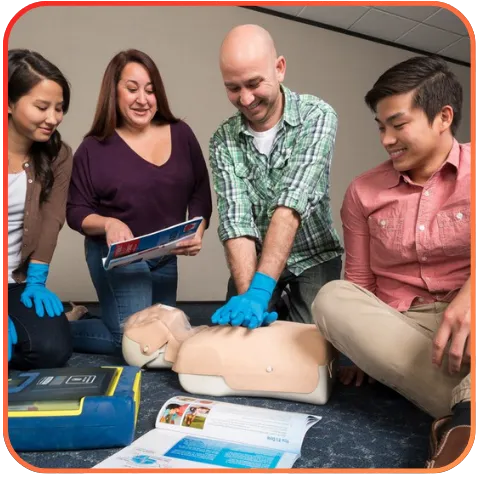 A group of people practicing CPR on a mannequin.