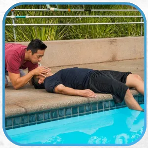 A person administering first aid near a pool.