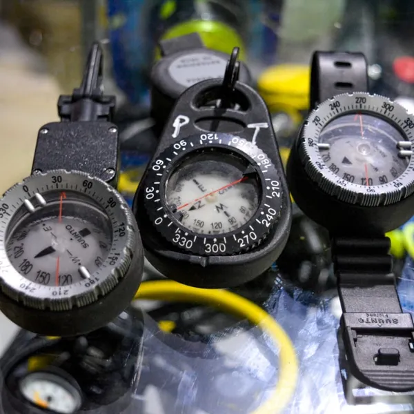 Close-up of scuba diving compasses and pressure gauges.