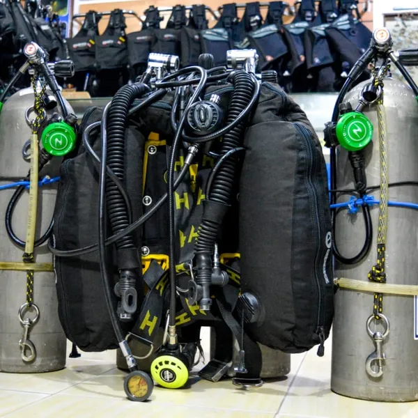 A set of technical scuba diving equipment with multiple tanks and regulators.